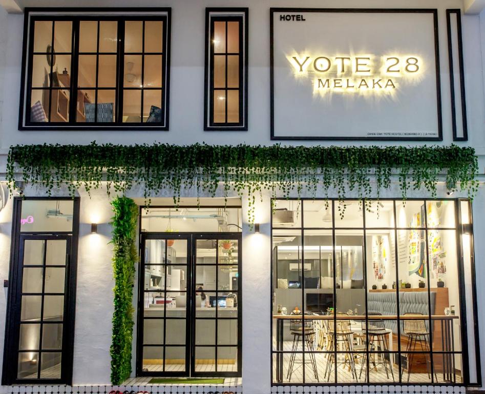 a store front with windows and ivy at Yote 28 in Malacca