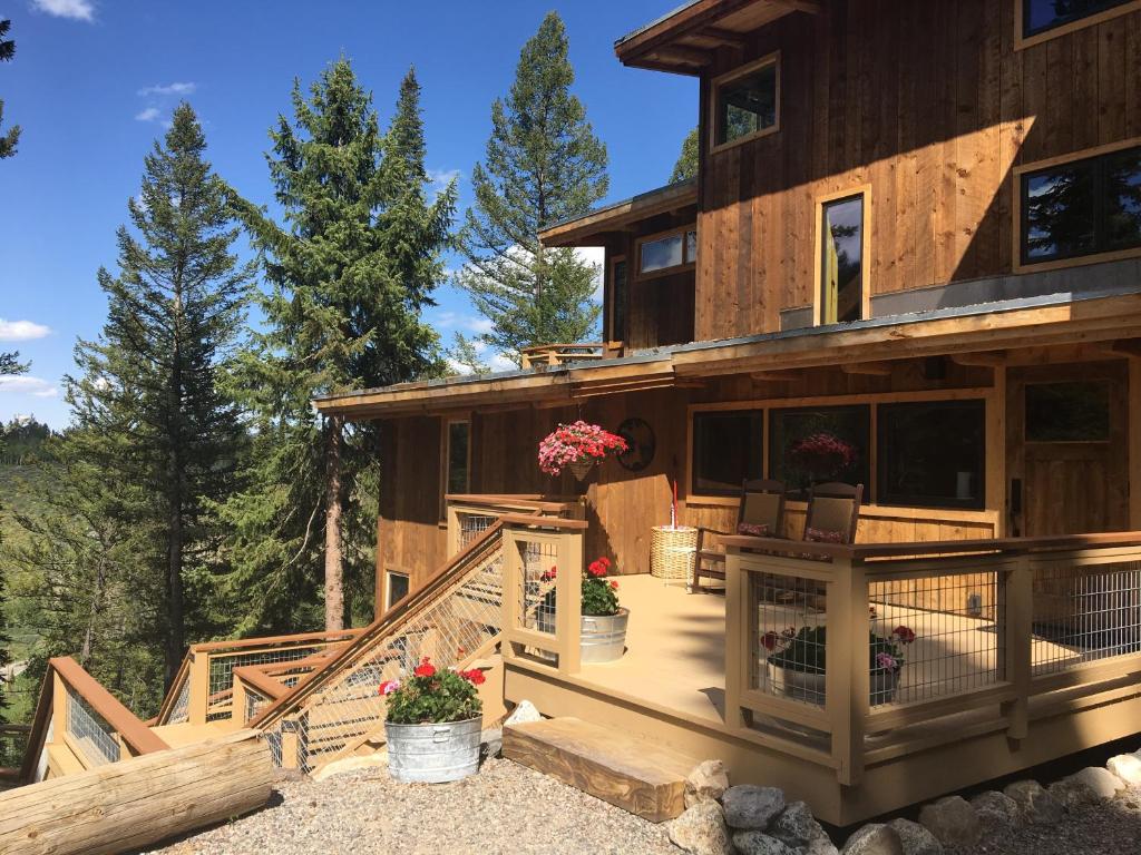 a house with a staircase leading to the front of it at Jackson Hole Hideout in Wilson