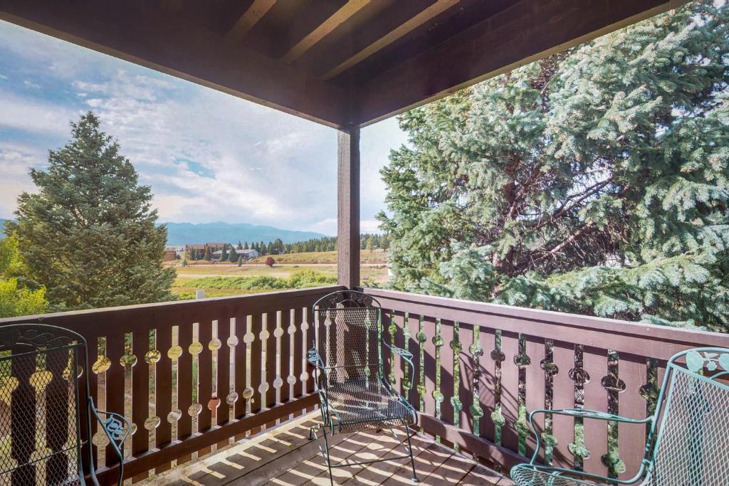 a balcony with a view of a tree and mountains at Snowfire in Angel Fire