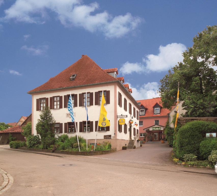 een gebouw met vlaggen op straat bij Landgasthof Schmidbaur in Donauwörth