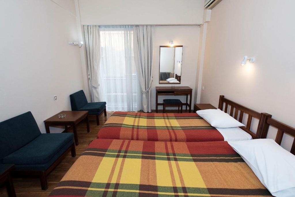 Postel nebo postele na pokoji v ubytování Hotel Alexandros