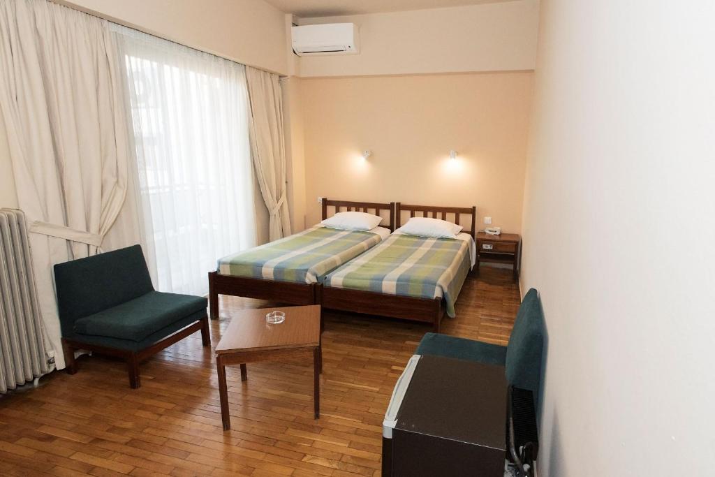 Postel nebo postele na pokoji v ubytování Hotel Alexandros