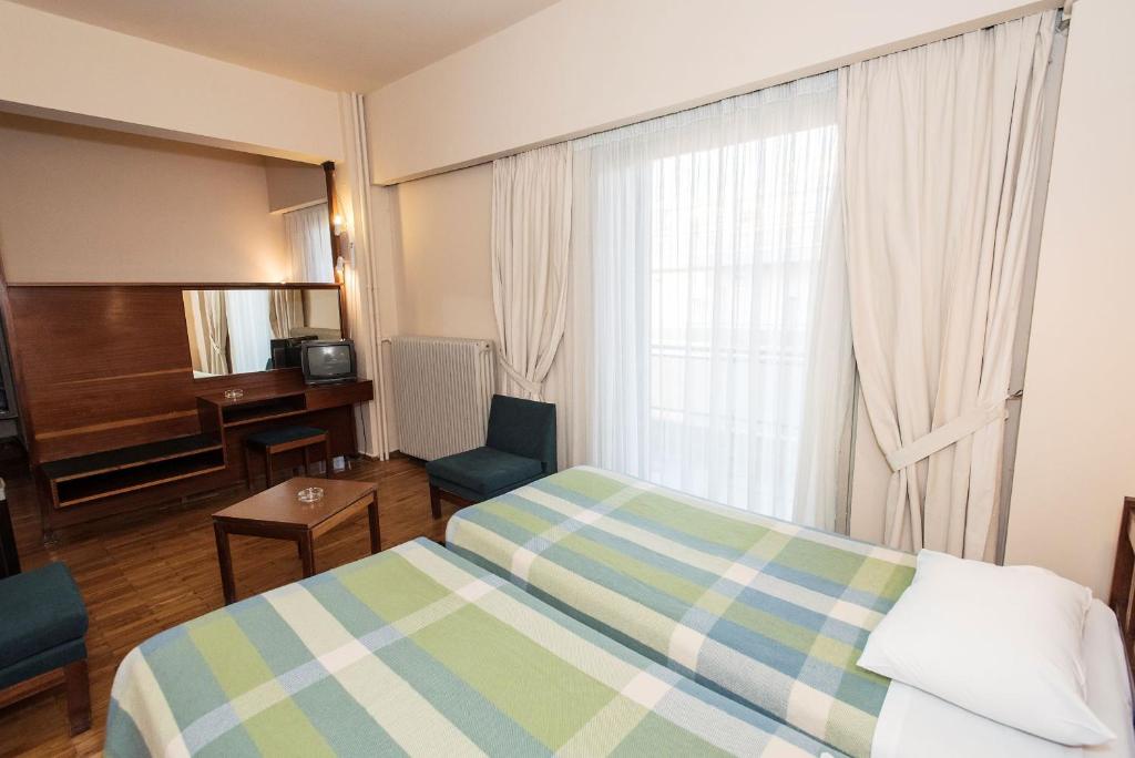 Postel nebo postele na pokoji v ubytování Hotel Alexandros