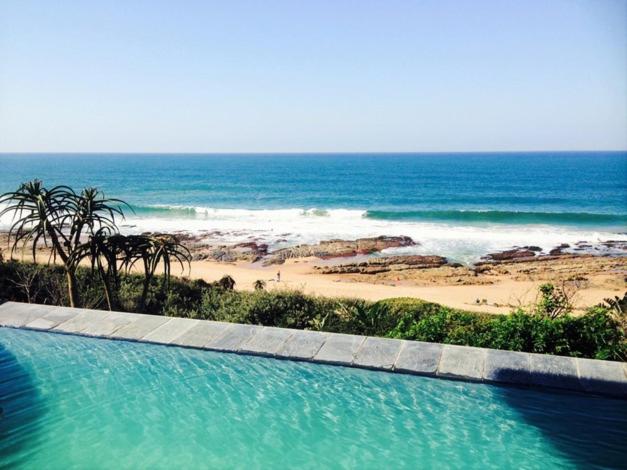 a swimming pool with a view of the beach at 25 Sovereign Sands in KwaDukuza
