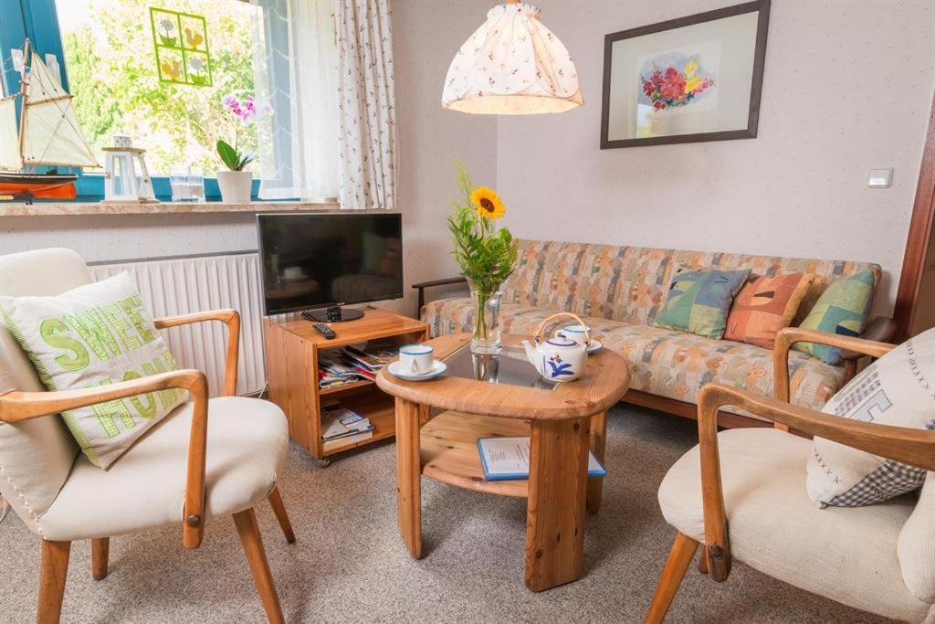 una sala de estar con un sofá y una mesa en Ferienwohnung Küssner, en Kiel