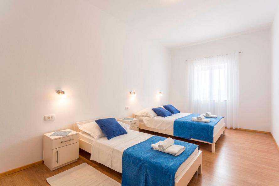 Postel nebo postele na pokoji v ubytování Apartmani Bezmalinović