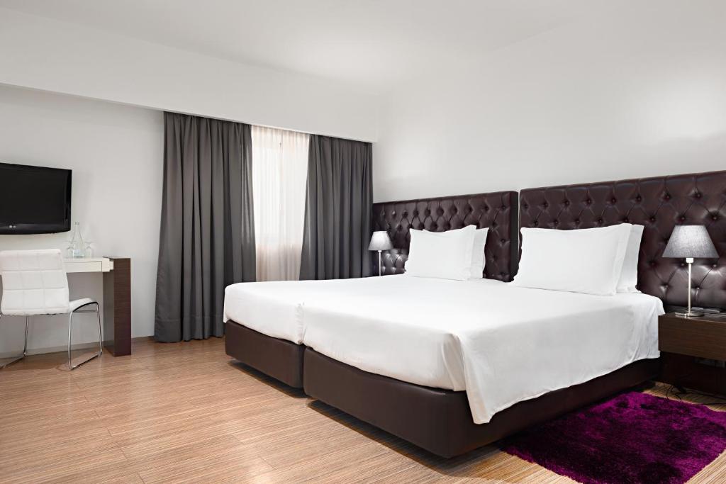 Postel nebo postele na pokoji v ubytování Hotel dos Zimbros