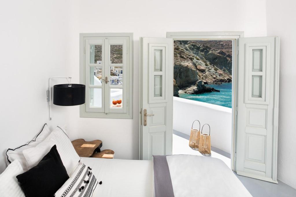 a bedroom with a bed and a view of the ocean at Blue Sand Boutique Hotel & Suites in Agali