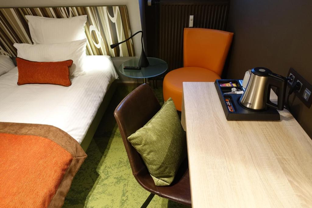 Postel nebo postele na pokoji v ubytování Hôtel du Parc Ath