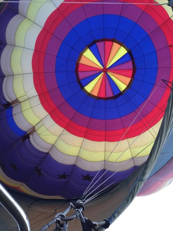 a colorful hot air balloon is being inflated at Winnie Homestay in Longtian