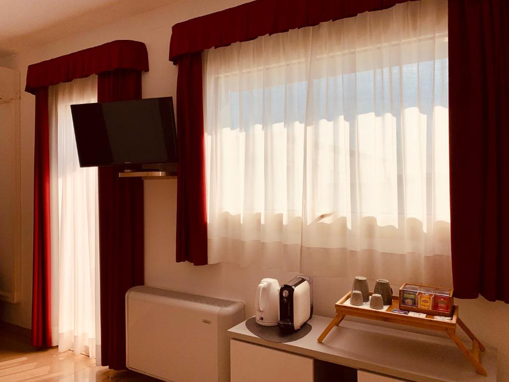 TV a/nebo společenská místnost v ubytování Hotel Verdi