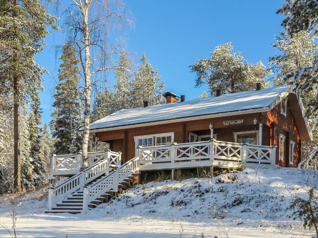 a log cabin in the woods in the snow at Holiday Home Tokkimus by Interhome in Luosto