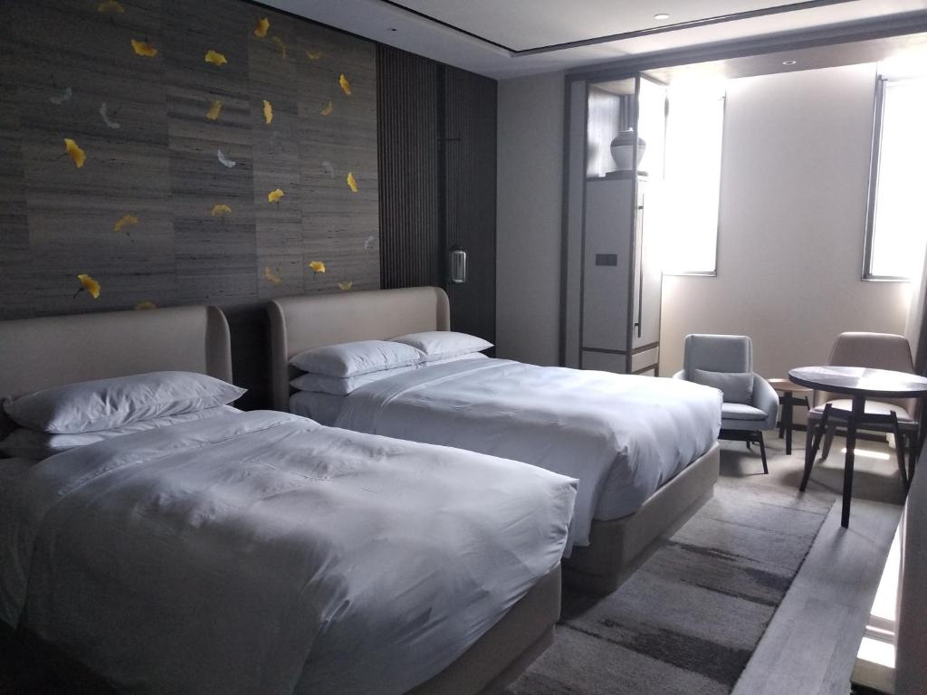 Postel nebo postele na pokoji v ubytování Yunhe Yebo Hotel (Shanghai International Tourism Resort Pudong Airport)