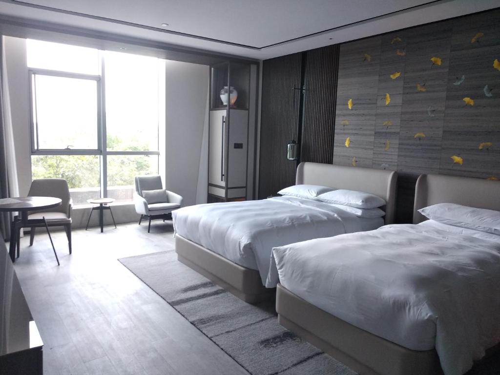 Postel nebo postele na pokoji v ubytování Yunhe Yebo Hotel (Shanghai International Tourism Resort Pudong Airport)