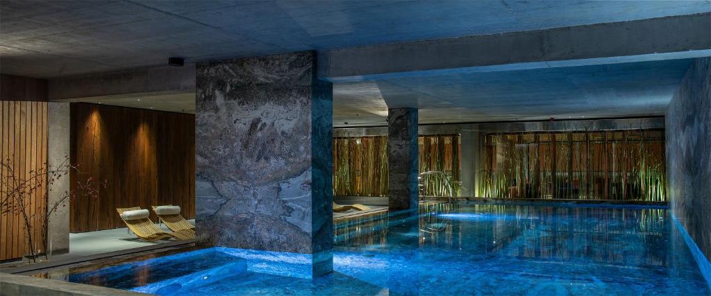 a swimming pool in a building with a pool at Hotel Warszawa in Warsaw