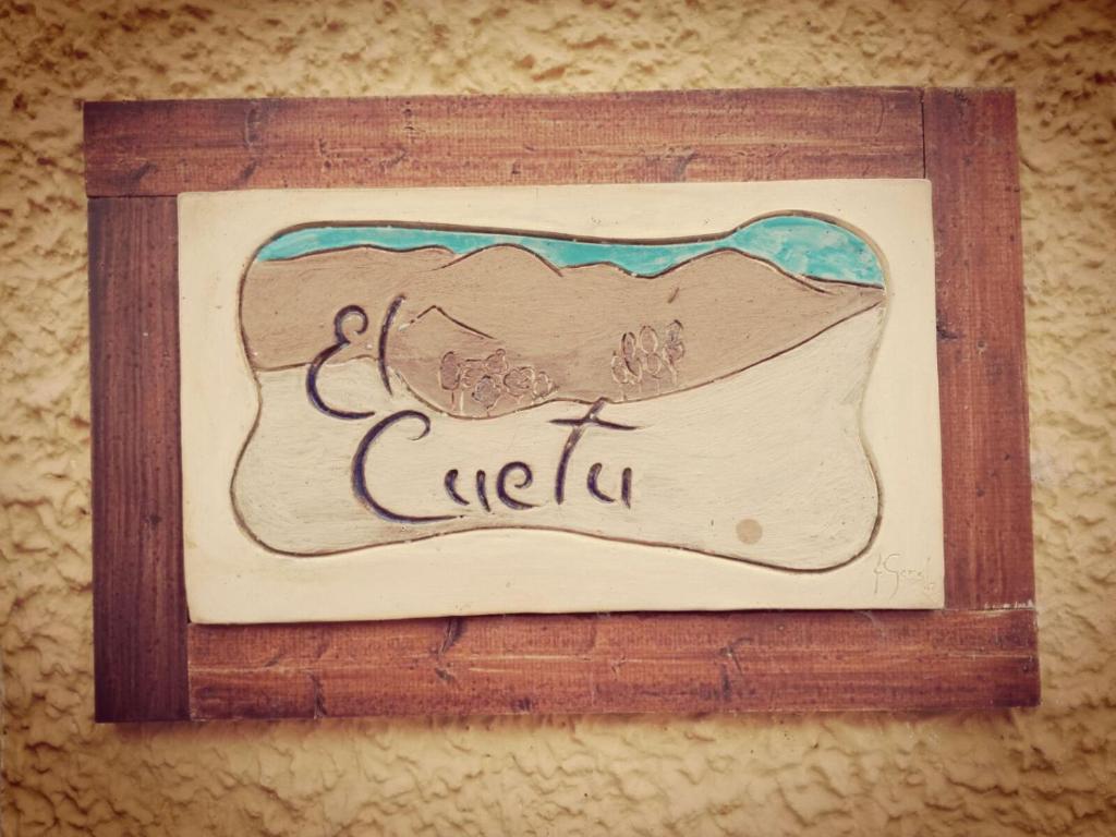 a picture in a wooden frame with the word cefilus at El Cuetu in Posada
