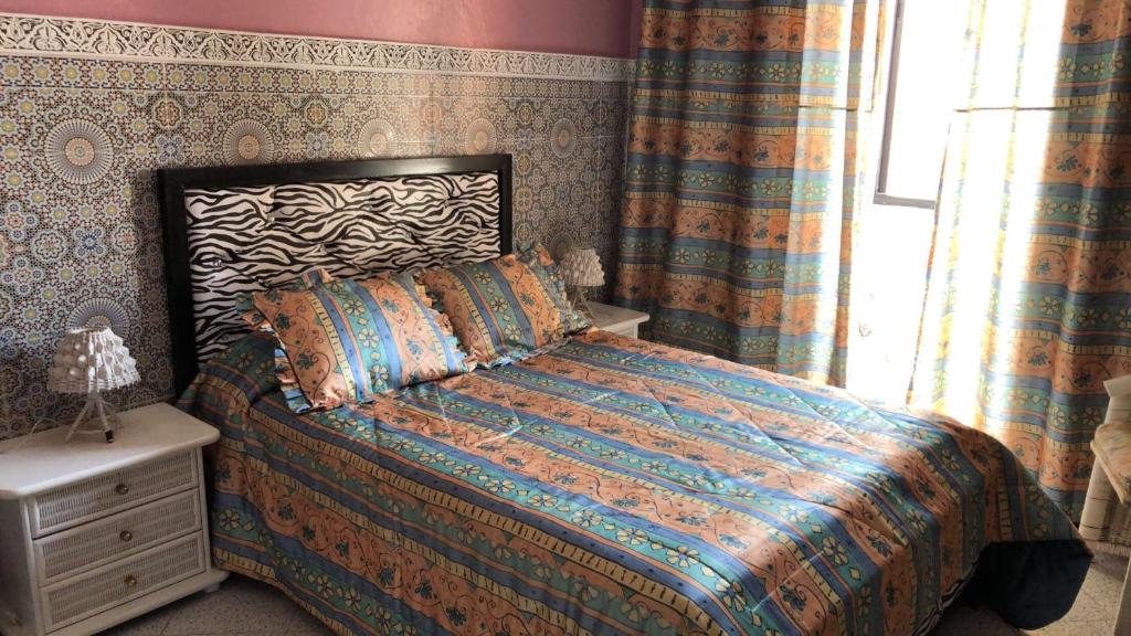 a bedroom with a bed and a window at Dar Soraya al Madina Marrakech in Marrakesh