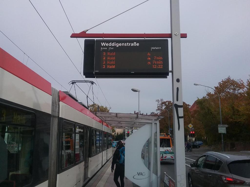 a sign at a train station with a train at City Appartement 5 in Freiburg im Breisgau