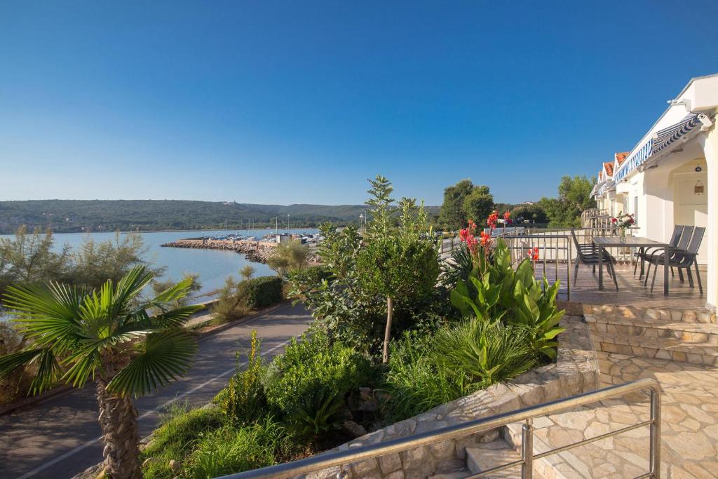 a balcony with a view of a river and a building at Apartments Tamaris in Čižići