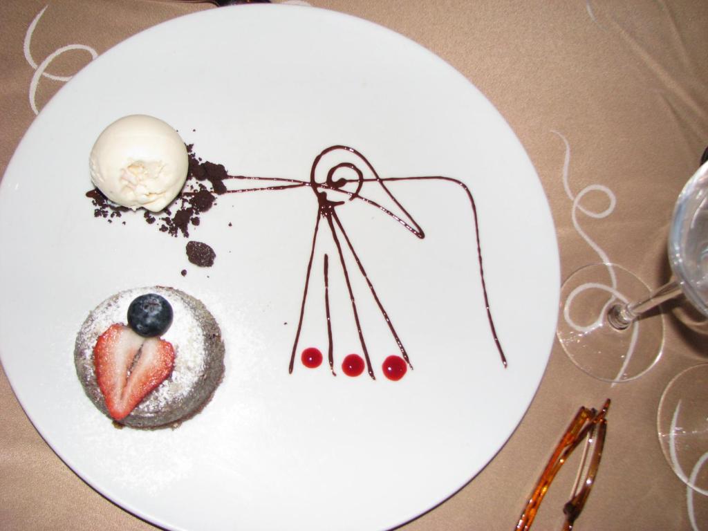 a white plate with some food on a table at Suites at Mayan Palace Vidanta Resort Riviera Maya in Playa del Carmen