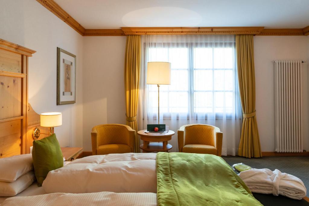 Postel nebo postele na pokoji v ubytování Vitalhotel Dosses