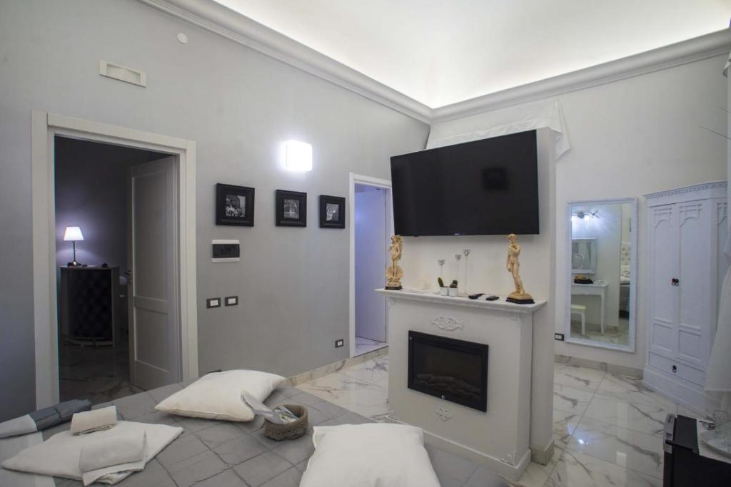 a living room with a fireplace and a flat screen tv at Barberini Dream in Rome