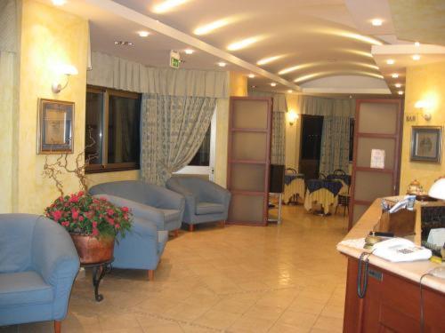 um quarto com sofás e cadeiras num quarto de hospital em Hotel La Fonte em Osimo