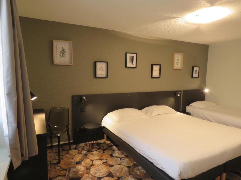 Postel nebo postele na pokoji v ubytování CIT'HÔTEL LE DAV Clermont-Ferrand Centre