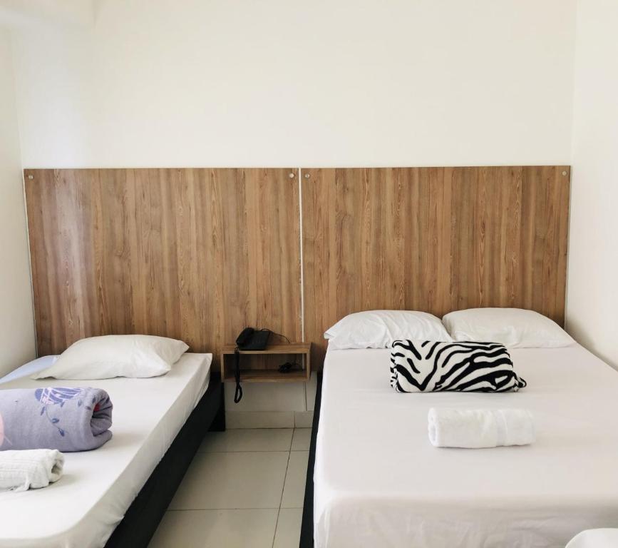 two beds sitting next to each other in a room at Hotel Center Plaza Plus in Cúcuta