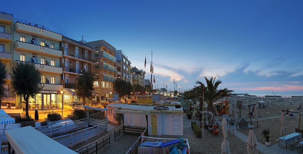 a view of a city with buildings and a beach at Hotel Cavalluccio Marino in Gabicce Mare