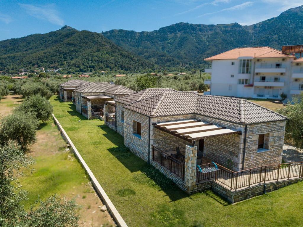 an overhead view of a row of houses with mountains in the background at Elaionas Stone Houses in Skala Potamias