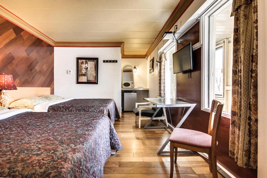 Postel nebo postele na pokoji v ubytování Motel Bellefeuille