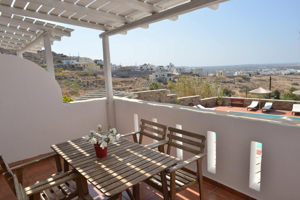 a table and chairs on a balcony with a view at Paradisia Villas in Naxos Chora