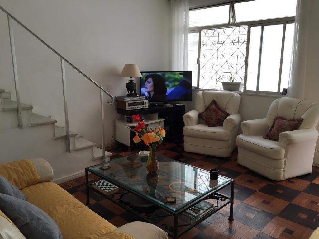 a living room with a couch and a table and a tv at Great Moments Copacabana in Rio de Janeiro