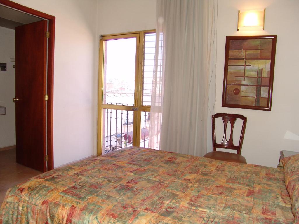 Postel nebo postele na pokoji v ubytování Hotel Posada Arcos