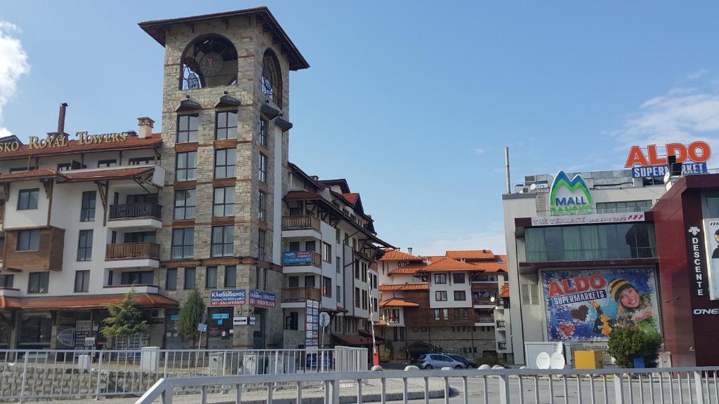 a tall building with a clock tower in a city at Koko's apartments in Bansko