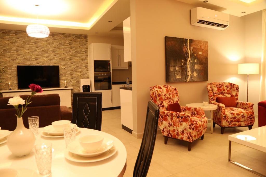 a living room with a table and chairs at Western Gate Residence 2 Amman in Amman