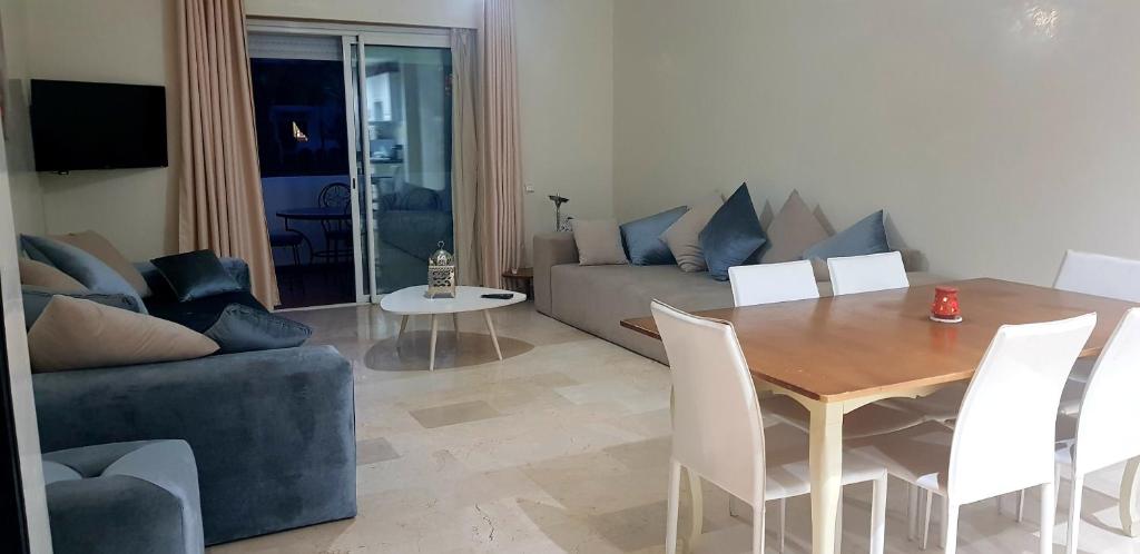 a living room with a table and a couch at Luxury Flat Marina Agadir in Agadir