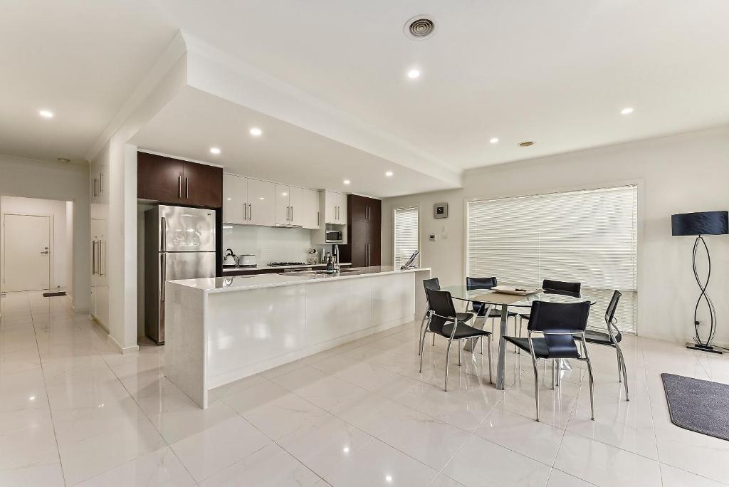 a kitchen and dining room with a table and chairs at Urban Corporate Apartment in Mount Gambier