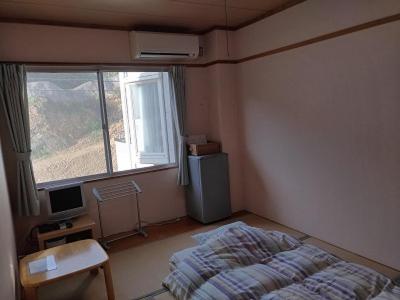 Postel nebo postele na pokoji v ubytování 海のお宿