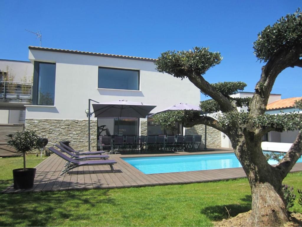 a villa with a swimming pool and a house at La Meilleraie in Les Sables-d'Olonne