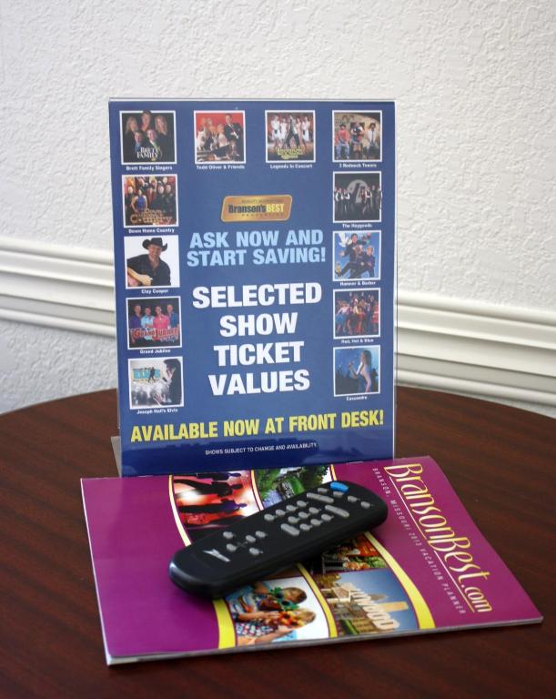 a book and a remote control sitting on a table at Branson's Best in Branson