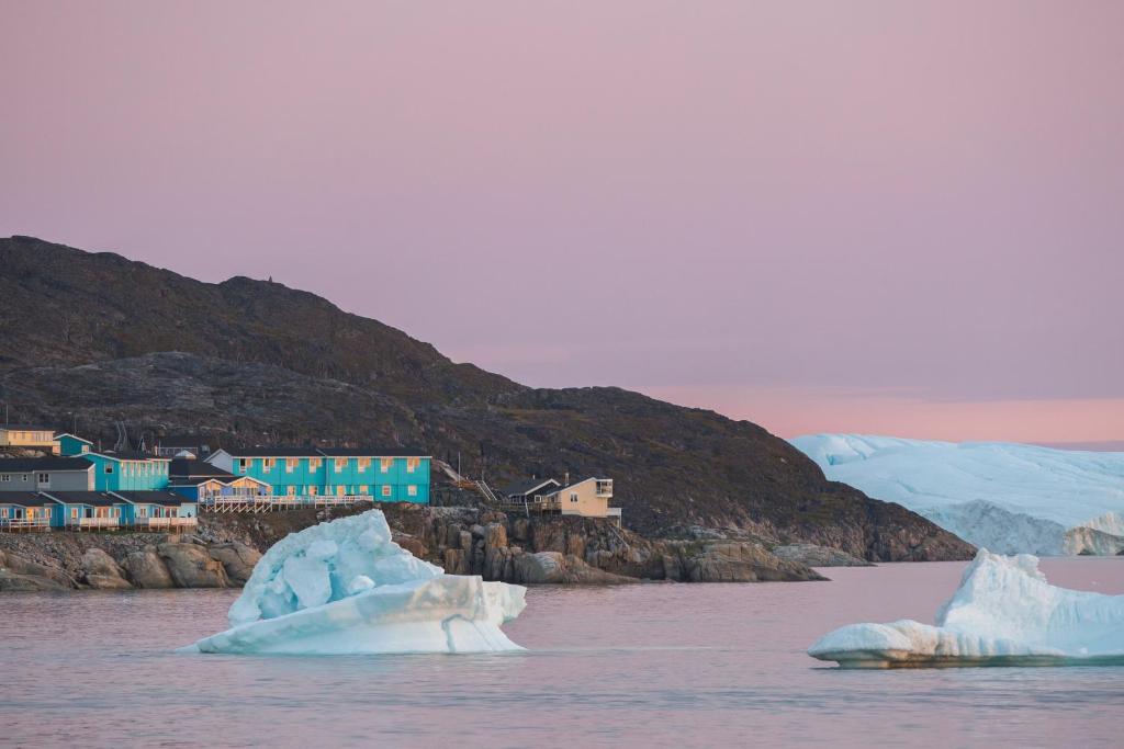 a group of icebergs in a body of water at Hotel Icefiord in Ilulissat