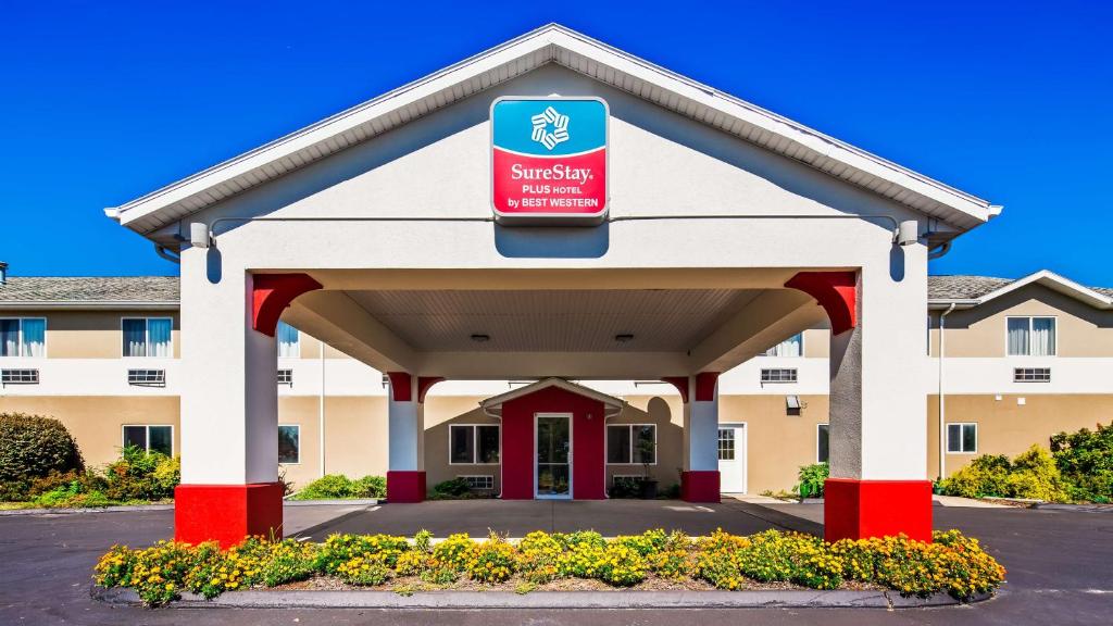 a hotel with a sign on the front of a building at SureStay Plus Hotel by Best Western Bettendorf in Bettendorf