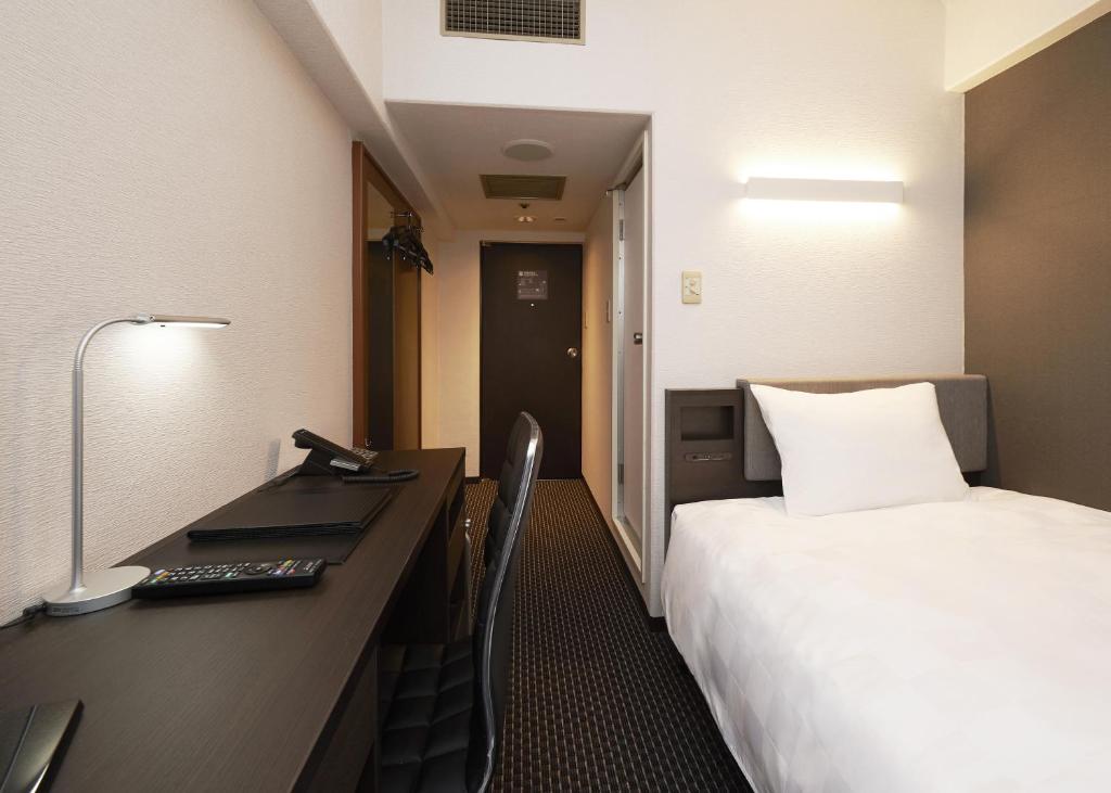 Postel nebo postele na pokoji v ubytování Hotel Consort Shin-Osaka