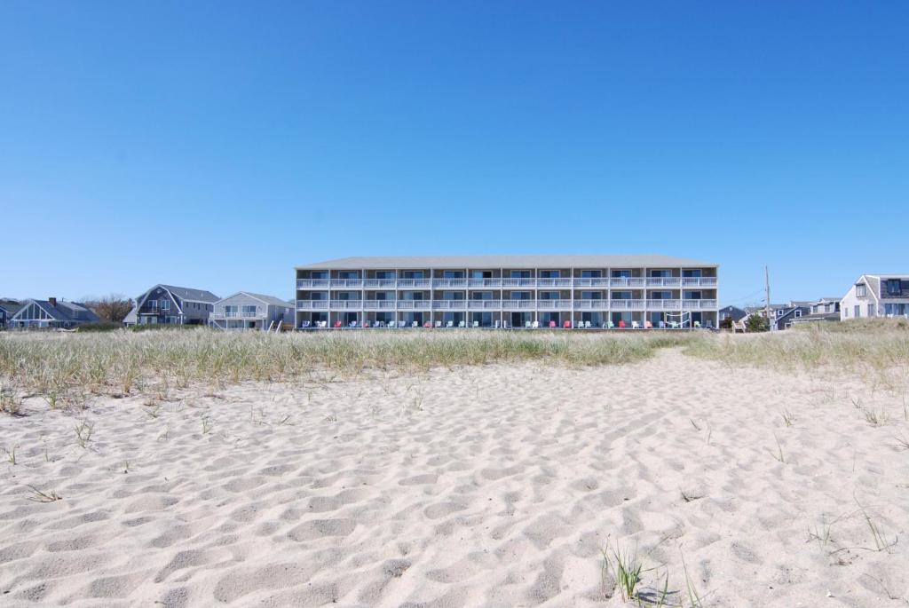 a building on the beach next to a sandy beach at Sandcastle Resort in Provincetown