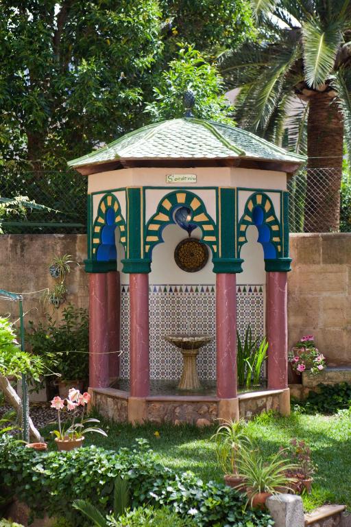 a small gazebo with a fountain in a garden at Turismo de Interior S&#39;Ardeviu in Sóller