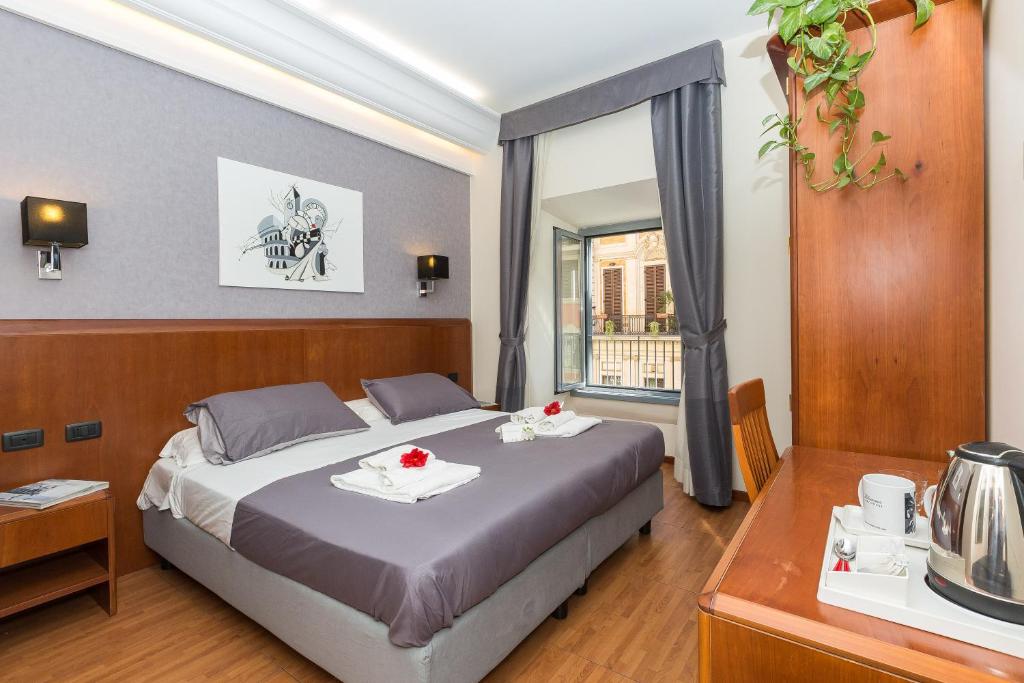 a bedroom with a large bed and a window at Filomena Arthouse in Rome