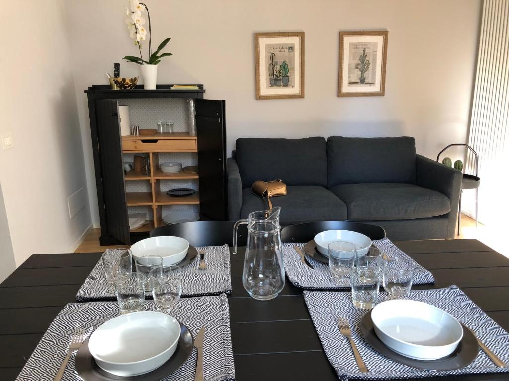 a living room with a table with plates and glasses at Belsiana Luxury Apartment in Rome