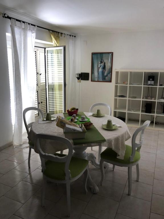 a dining room with a table and chairs and a table and chairsktop at Villa Cecilia in Pozzuoli